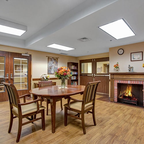 Dining room with fireplace at Sunnyside Healthcare Center